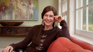 Louise Erdrich '76 sits on a couch at Dartmouth's Montgomery House