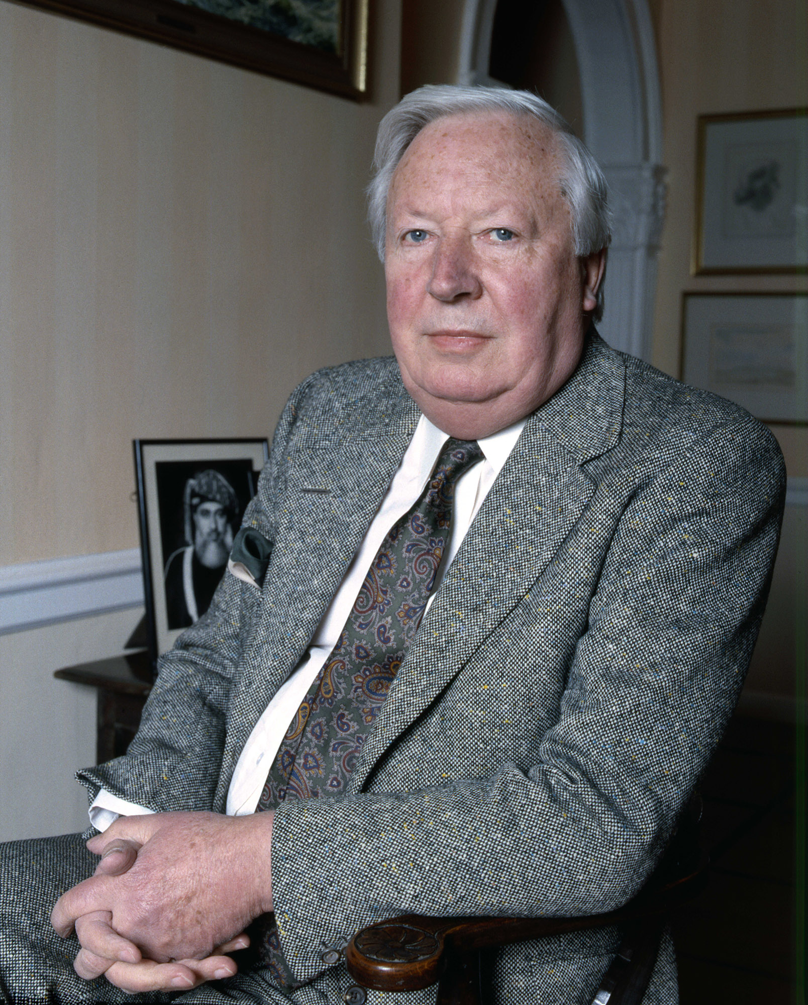 Edward Heath sitting in a chair