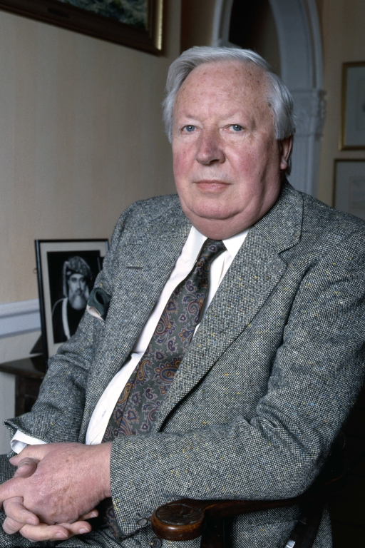 Edward Heath sitting in a chair