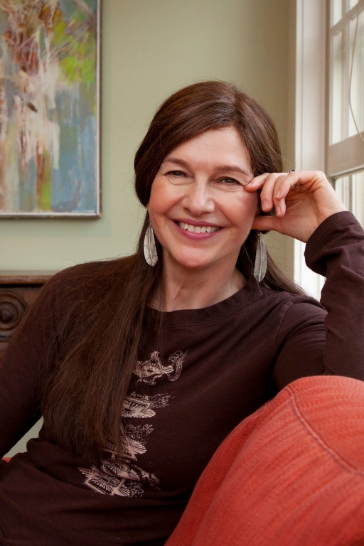 Louise Erdrich '76 sits on a couch at Dartmouth's Montgomery House